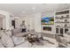 Spacious living room with a modern fireplace and built-in shelving at 18394 N 97Th Pl, Scottsdale, AZ 85255