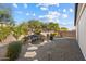 Landscaped backyard with water feature and stone pathway at 18394 W Ipswitch Way, Surprise, AZ 85374