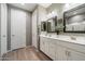 Double vanity bathroom with modern white cabinets and mirrors at 18394 W Ipswitch Way, Surprise, AZ 85374