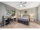 Bright bedroom featuring a comfortable bed and built-in workspace at 18394 W Ipswitch Way, Surprise, AZ 85374