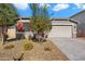 Single-story home with a two-car garage and landscaped front yard at 18394 W Ipswitch Way, Surprise, AZ 85374