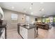 Open kitchen with island and view into living room at 18394 W Ipswitch Way, Surprise, AZ 85374