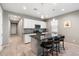 Modern kitchen with island, white cabinets, and granite countertops at 18394 W Ipswitch Way, Surprise, AZ 85374