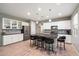 Modern kitchen with white cabinets, island, and granite countertops at 18394 W Ipswitch Way, Surprise, AZ 85374