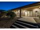 Landscaped backyard with stairs leading to a covered patio at 21310 E Orchard Ln, Queen Creek, AZ 85142