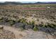 Aerial view showing desert property with a small home and surrounding landscape at 26956 N Shirley Rd, San Tan Valley, AZ 85143