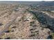 Aerial view of a desert property with a house and surrounding desert landscape at 26956 N Shirley Rd, San Tan Valley, AZ 85143