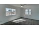 Well-lit bedroom with two windows and ceiling fan at 709 W 2Nd Pl, Mesa, AZ 85201