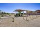 Community playground with shade structure, slides, and swings at 9730 W Agora Ln, Tolleson, AZ 85353