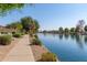 Relaxing walkway along a peaceful lake in a residential community at 10720 W Sierra Pinta Dr, Sun City, AZ 85373