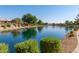 Serene lakefront view with walking path and lush landscaping at 10720 W Sierra Pinta Dr, Sun City, AZ 85373