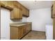 Laundry room with wood cabinets and tile floor at 1137 S 131St St, Gilbert, AZ 85233