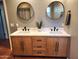 Double vanity bathroom with wood cabinets and quartz countertops at 1310 W Pasadena Ave, Phoenix, AZ 85013