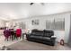 Living room with black leather couch and view into kitchen at 1778 S Saddle St, Gilbert, AZ 85233