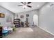 Bright living room with carpeted floors, bookshelves, and a ceiling fan at 1778 S Saddle St, Gilbert, AZ 85233