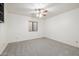 Cozy bedroom with window, ceiling fan, and carpet at 1822 E Linda Ln, Gilbert, AZ 85234