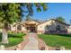 Single-story home with brick accents and a lush lawn at 1822 E Linda Ln, Gilbert, AZ 85234