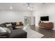 Bright living room with L-shaped sectional sofa and sliding glass door at 253 W Tamarack Dr, San Tan Valley, AZ 85140