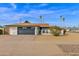 Front view of a single story home with a black garage door at 3301 W Belmont Ave, Phoenix, AZ 85051