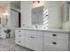 Bathroom boasting a double vanity with white cabinets and quartz countertops at 4072 E Weston Ln, San Tan Valley, AZ 85140