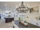 Elegant dining room with chandelier and view into kitchen at 4072 E Weston Ln, San Tan Valley, AZ 85140