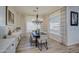 Elegant dining room with chandelier, large windows, and farmhouse table at 4072 E Weston Ln, San Tan Valley, AZ 85140