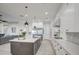 Modern kitchen with white cabinets, large island, and stainless steel appliances at 4072 E Weston Ln, San Tan Valley, AZ 85140