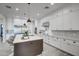 Modern kitchen with white cabinets, large island, and stainless steel appliances at 4072 E Weston Ln, San Tan Valley, AZ 85140