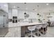 Modern kitchen with white cabinets, large island, and stainless steel appliances at 4072 E Weston Ln, San Tan Valley, AZ 85140