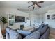 Living room with sectional sofa, fireplace, and built-in shelving at 4981 E Shapinsay Dr, San Tan Valley, AZ 85140