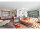 Bright and airy living room with mid-century furniture and large windows at 5250 W Harmont Dr, Glendale, AZ 85302