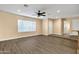 Spacious living room with wood-look tile flooring and a ceiling fan at 5704 W Hearn Rd, Glendale, AZ 85306