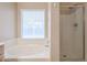 Bathroom featuring garden tub and shower at 7275 W Tina Ln, Glendale, AZ 85310