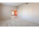 Bedroom with neutral carpeting and view into living room at 7275 W Tina Ln, Glendale, AZ 85310