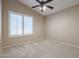 Well-lit bedroom with ceiling fan and window shutters at 7275 W Tina Ln, Glendale, AZ 85310