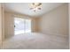 Bright bedroom with carpet flooring and sliding door to backyard at 7275 W Tina Ln, Glendale, AZ 85310