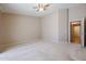 Spacious bedroom with carpet flooring and access to hallway at 7275 W Tina Ln, Glendale, AZ 85310