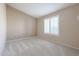 Bright bedroom with neutral carpeting and window shutters at 7275 W Tina Ln, Glendale, AZ 85310