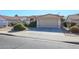 House exterior with a two-car garage and manicured landscaping at 7275 W Tina Ln, Glendale, AZ 85310