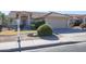 House exterior with a two-car garage and manicured landscaping at 7275 W Tina Ln, Glendale, AZ 85310