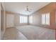 Living room with neutral carpeting and plantation shutters at 7275 W Tina Ln, Glendale, AZ 85310