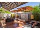 Relaxing patio with water feature, seating area, and shade umbrellas at 7318 E Palo Verde Dr # 10, Scottsdale, AZ 85250