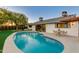 Inviting kidney-shaped pool with patio furniture and landscaping at 8113 E Buena Terra Way, Scottsdale, AZ 85250