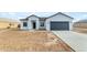 Newly constructed home with gray garage door and desert landscaping at 10298 W Devonshire Dr, Arizona City, AZ 85123