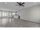 Open living space with kitchen island and gray tile floors at 10298 W Devonshire Dr, Arizona City, AZ 85123