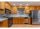 Bright kitchen featuring wood cabinets and stainless steel appliances at 1161 S Grand Dr, Apache Junction, AZ 85120