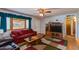 Living room with a red couch and wood entertainment center at 1161 S Grand Dr, Apache Junction, AZ 85120