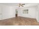 Bright bedroom with tile floors, ceiling fan, and access to bathroom at 12739 W Castle Rock Dr, Sun City West, AZ 85375