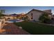 Landscaped backyard featuring a kidney-shaped pool and artificial turf at 1320 W Muirwood Dr, Phoenix, AZ 85045