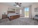 Spacious main bedroom with king-size bed and access to balcony at 13733 W Redfield Rd, Surprise, AZ 85379